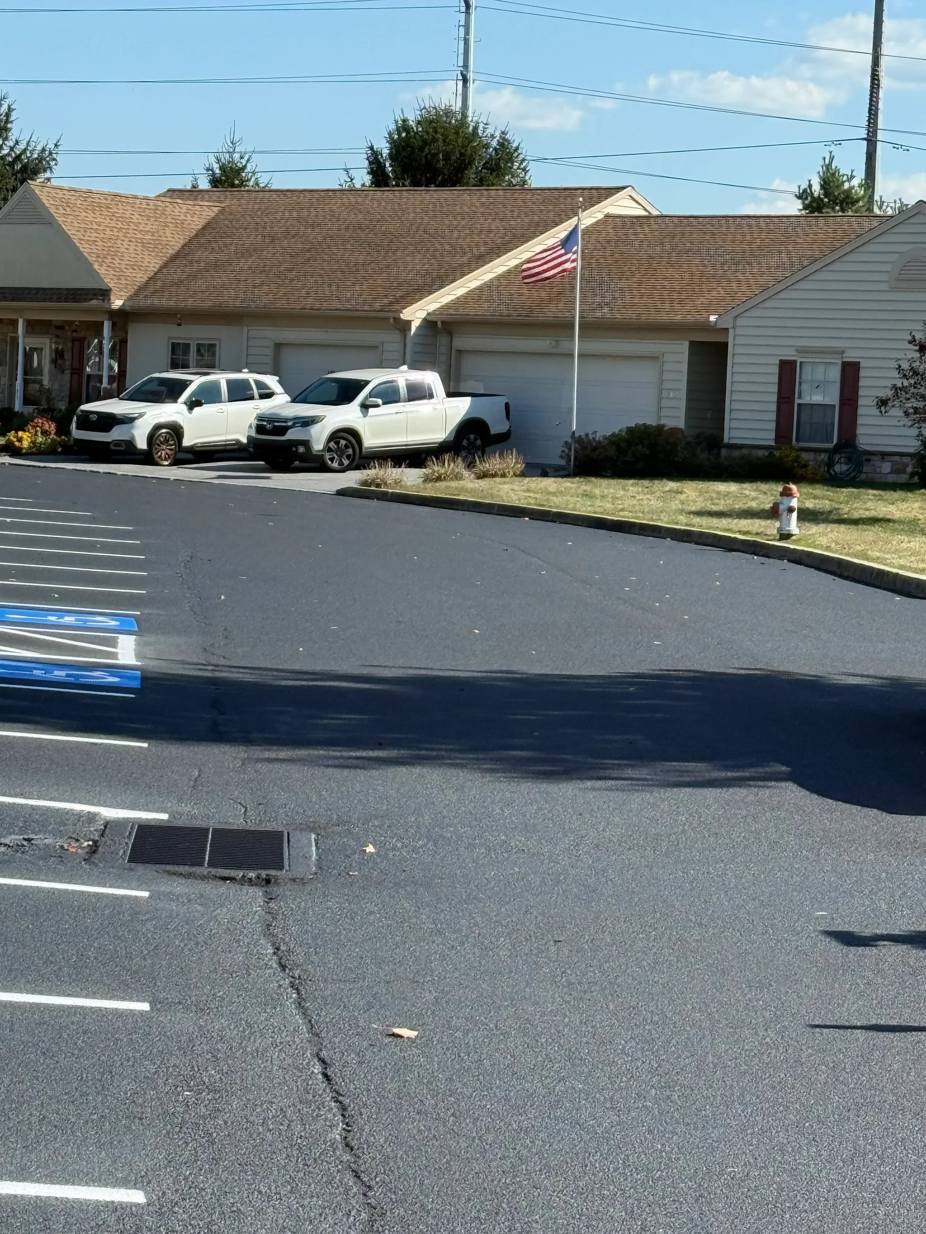 Sealed asphalt parking lot with white line striping and parking space markings