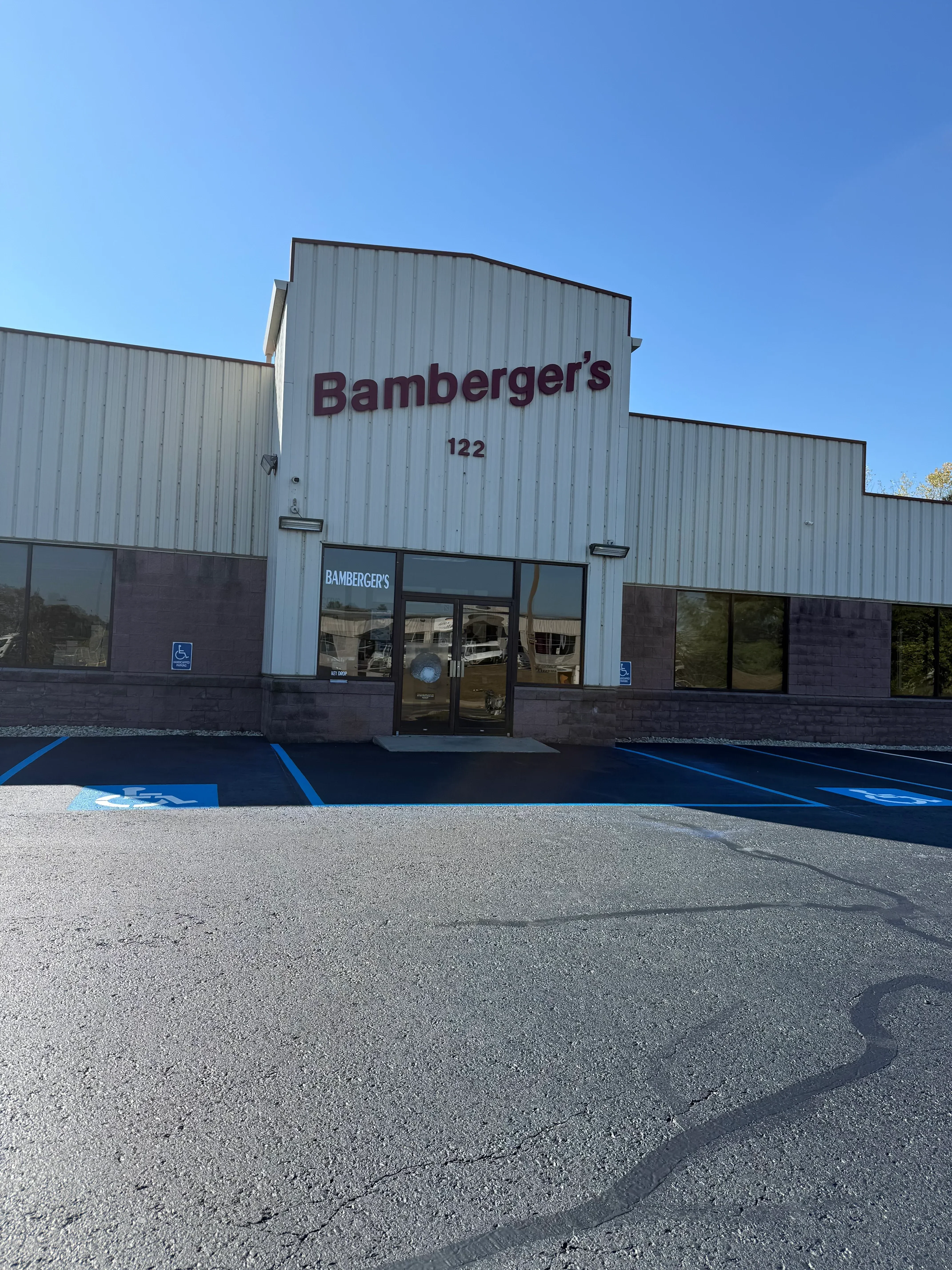 Newly paved asphalt parking lot with white striping and accessible parking space markings