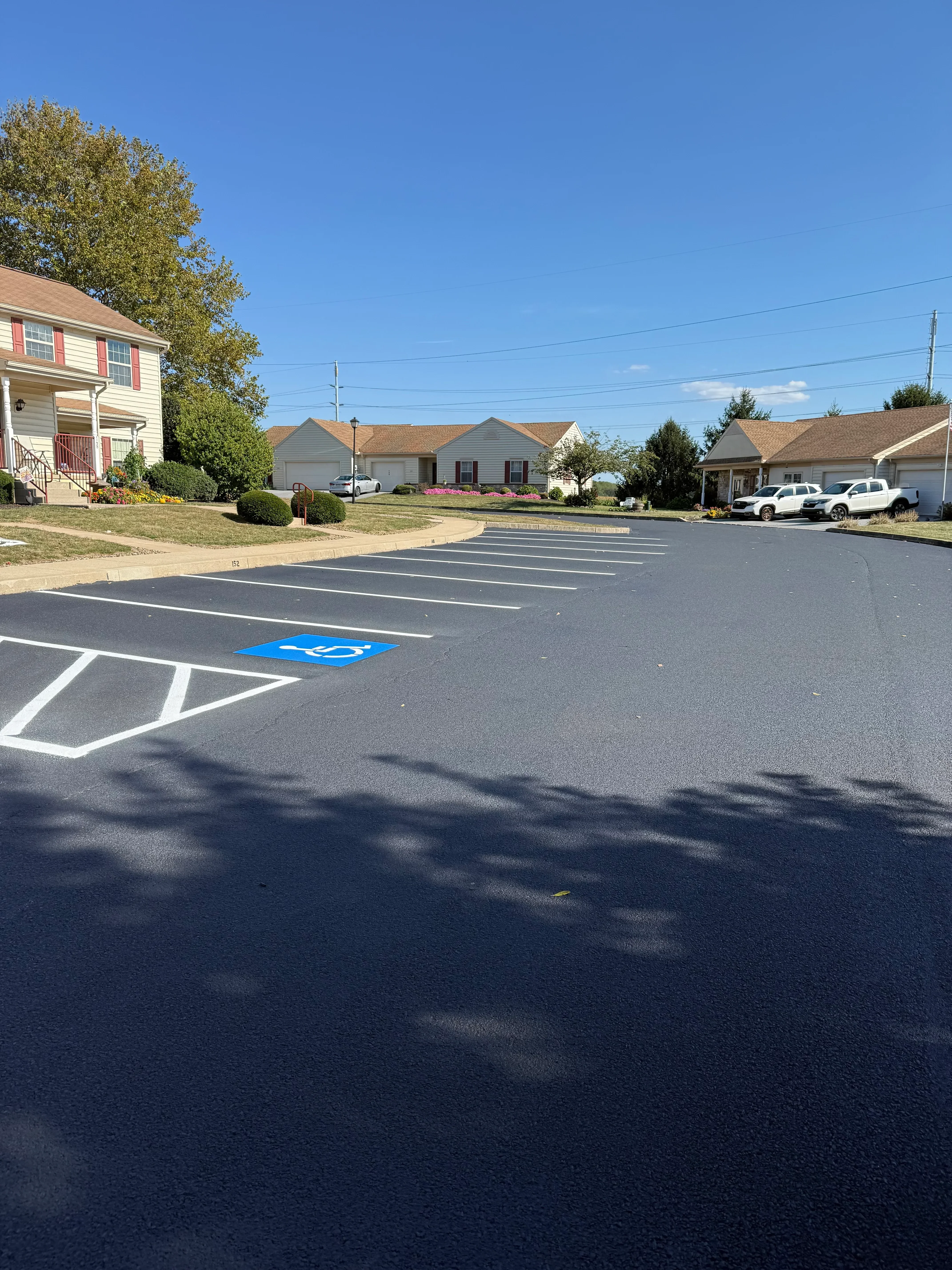 Sealed asphalt driveway with white striping and directional arrow markings